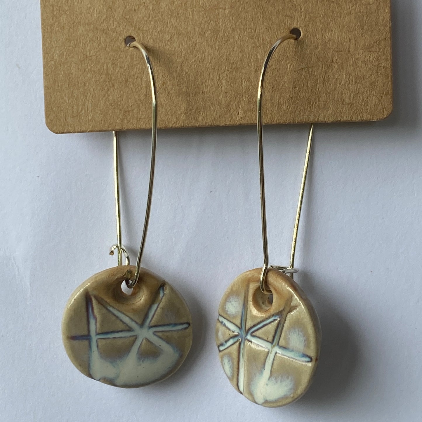 Disc earrings on long kidney hooks - milk glass geometric