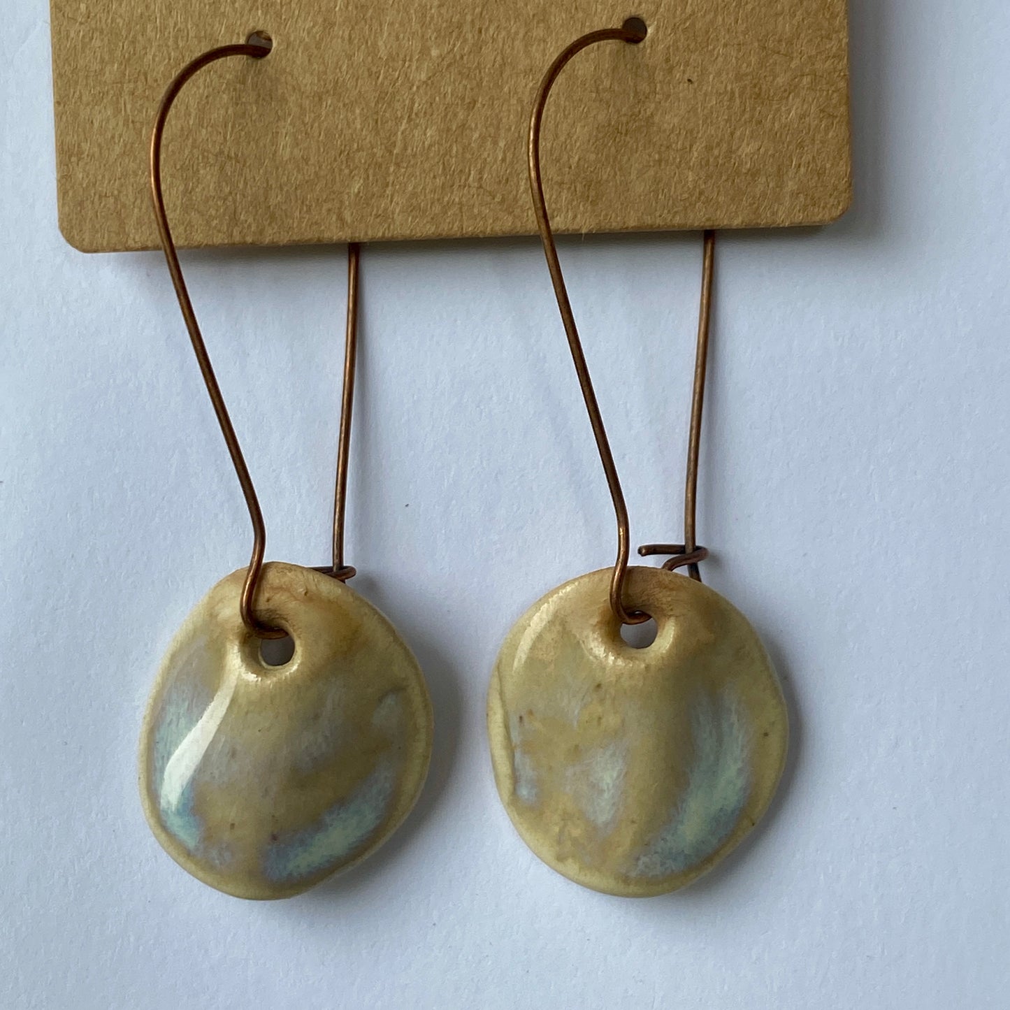 Disc earrings on long kidney hooks - milk glass