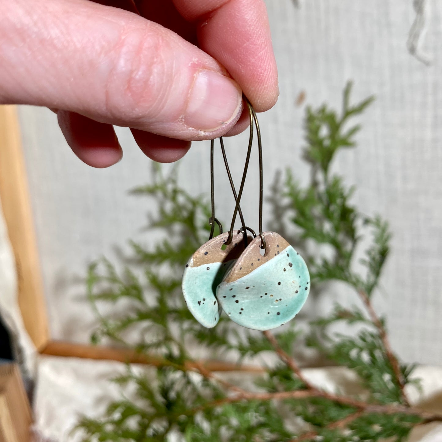 Disc earrings on long kidney hooks - mint
